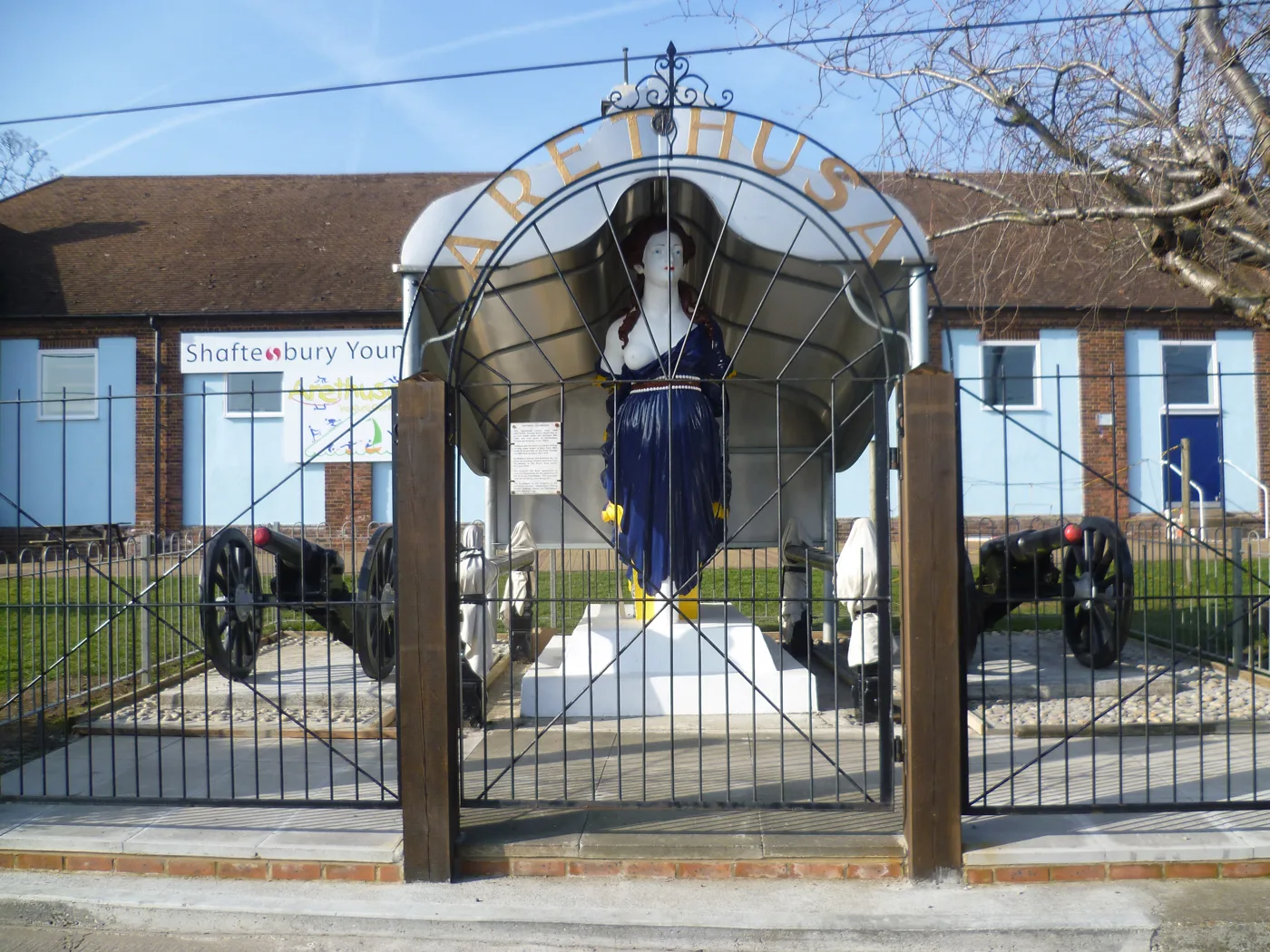 The grade II listed figurehead of HMS Arethusa at Lower Upnor, with the Shaftesbury Young People buildings behind it. The buildings are the ones proposed for demolition