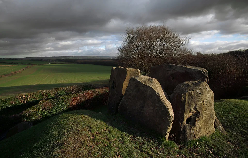 The chamber stones of Coldrum long barrow, looking out over the fields below